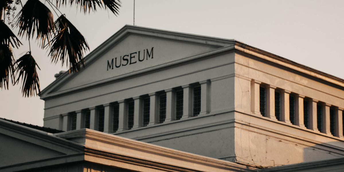 Historic museum building with a prominent sign and classic architectural features