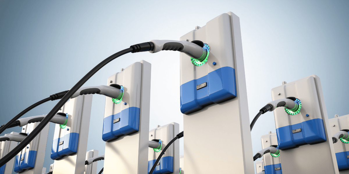 Multiple electric vehicle charging stations with plugged cables and illuminated indicators