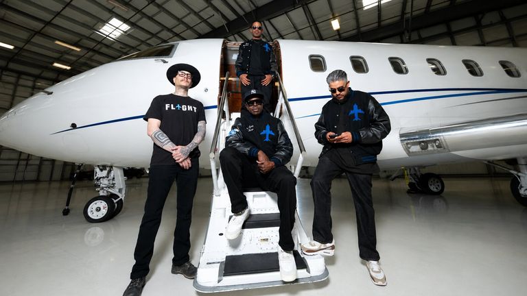 Flight Bernal Heights team posing on private jet stairs inside an aircraft hangar.