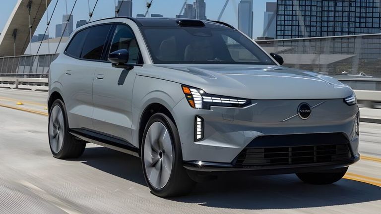 A 2021 Volvo XC40 driving on a highway, showcasing its hybrid, plug-in hybrid, and electric car options.