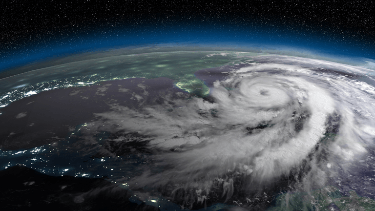 Aerial view of a powerful hurricane swirling over the ocean at night