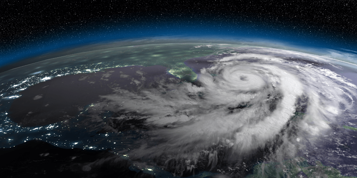 Aerial view of a powerful hurricane swirling over the ocean at night