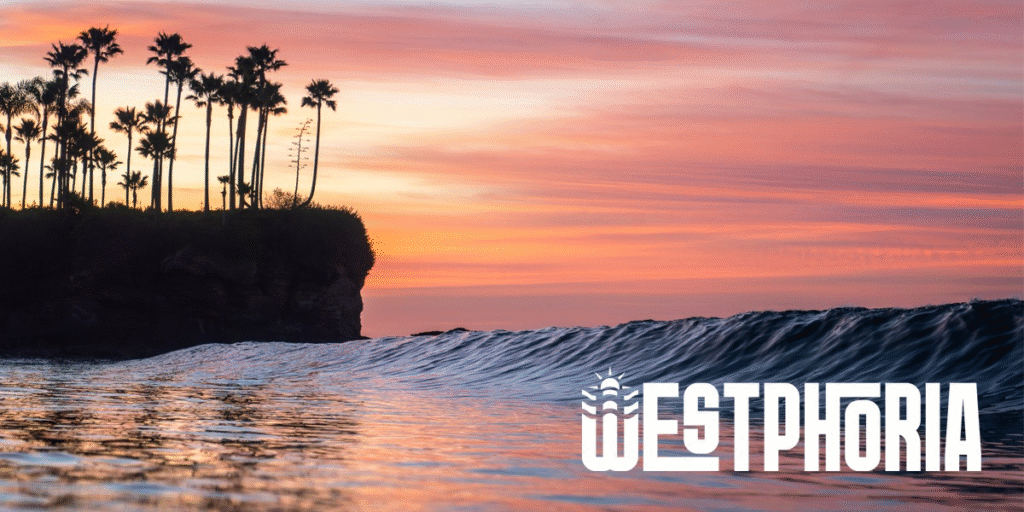 Palm-lined cliff beside rolling ocean wave at vibrant sunset, with Westphoria logo overlaid.